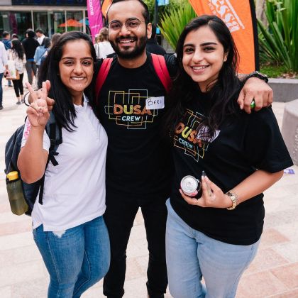 Three DUSA Crew members standing arm in arm at the DUSA Burwood Market Day