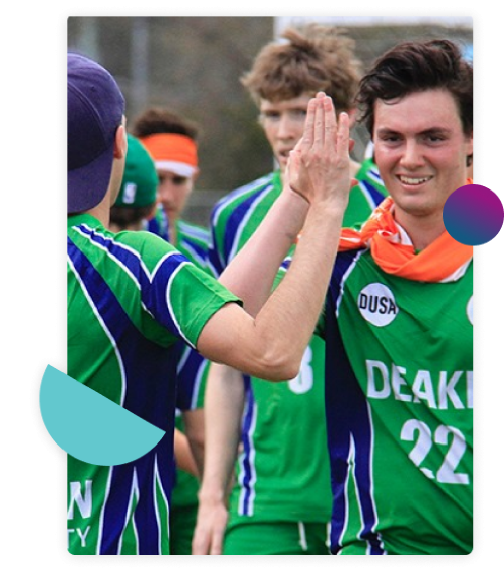 A group of male students in Deakin sports uniforms high fiving each other