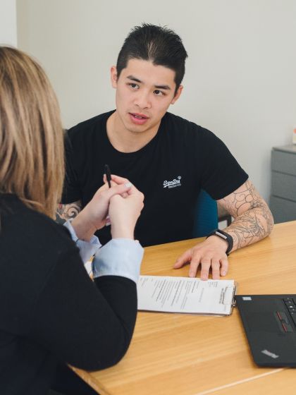Advocacy staff member sitting at a table with a student about their options
