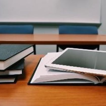 Textbooks sitting on a desk in a classroom