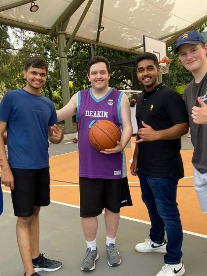 Group of student posing with basketball after come & try sport session and giving a thumbs up