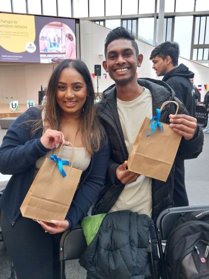 Sri Lankan Student Club at Clubs Showcase holding up goodie bags